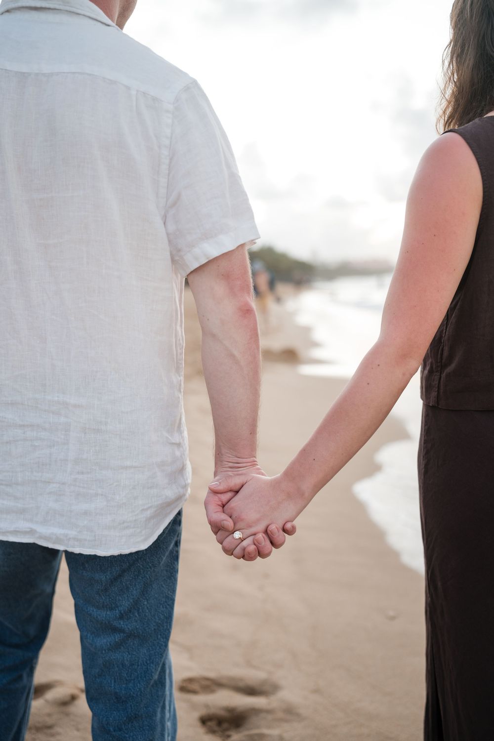 Couple standing together on beach during engagement photos in Puerto Rico