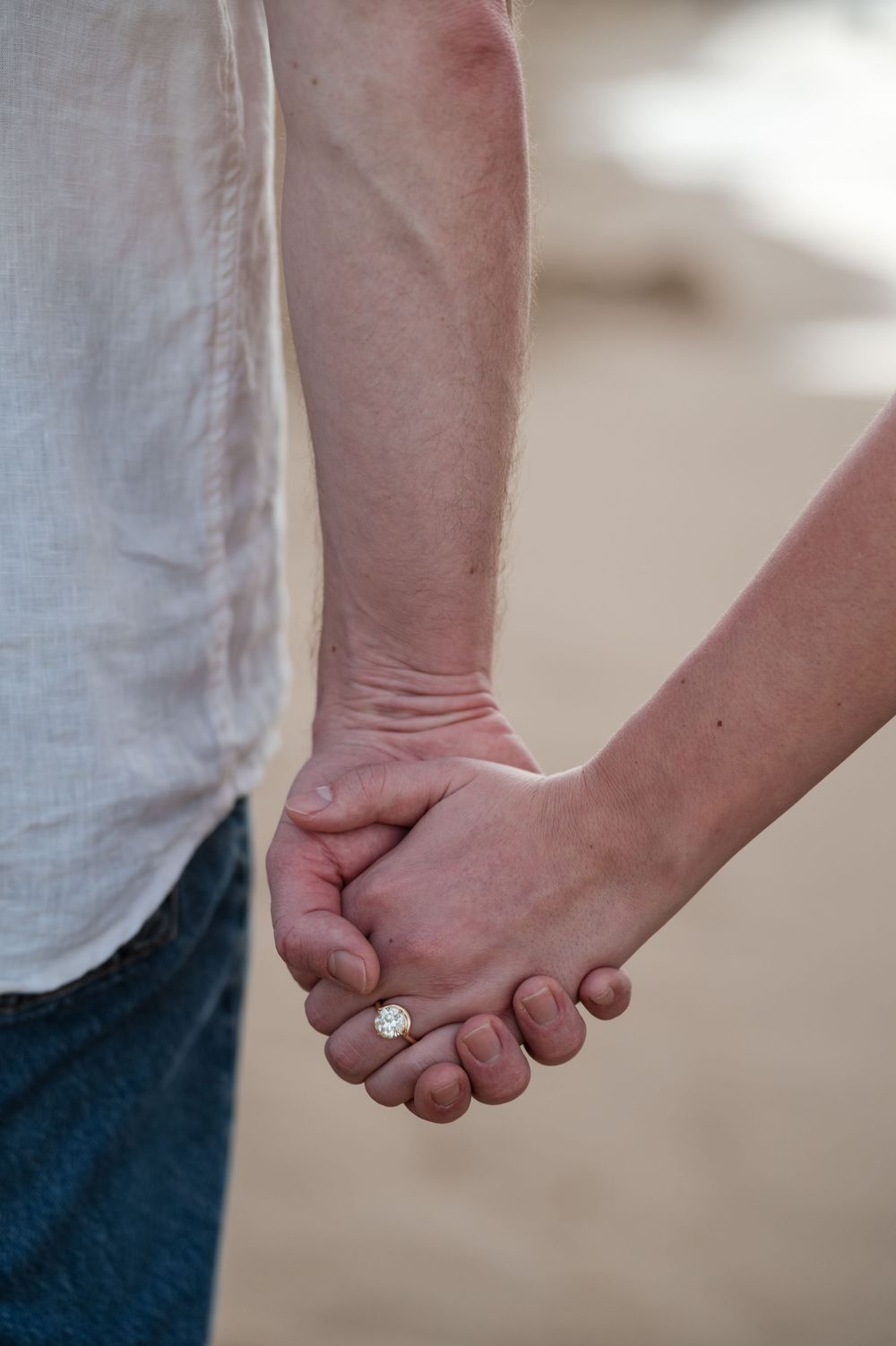 Close up of couple holding hands during beach engagement session in Puerto Rico