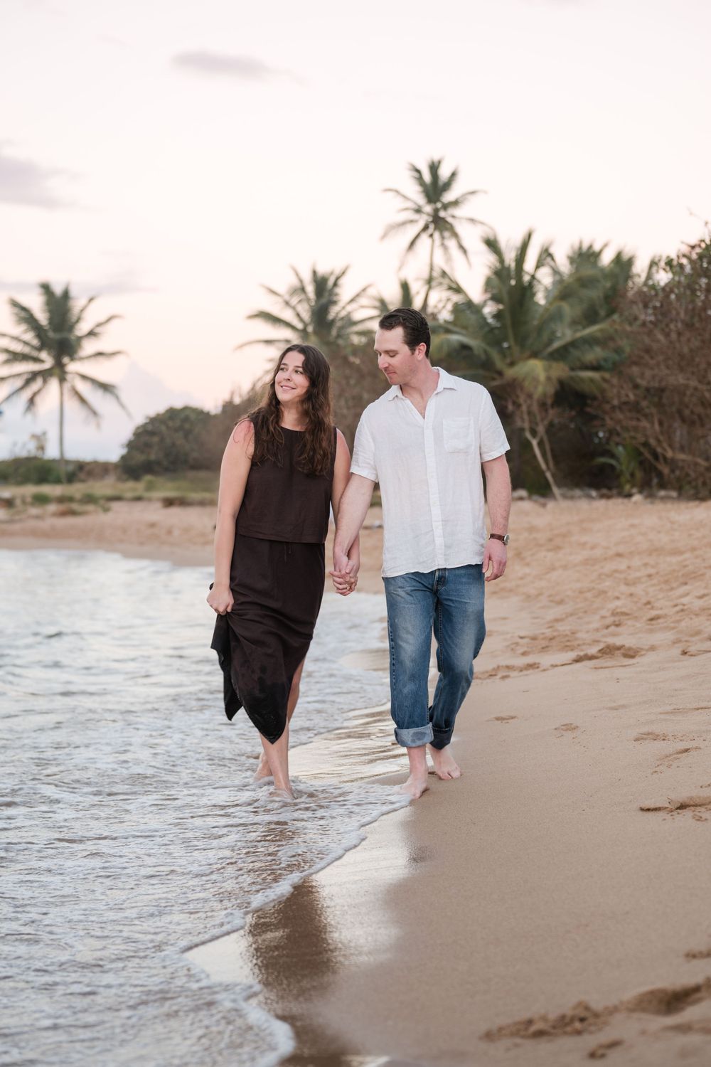 Couple walking side by side on beach during engagement session in Puerto Rico