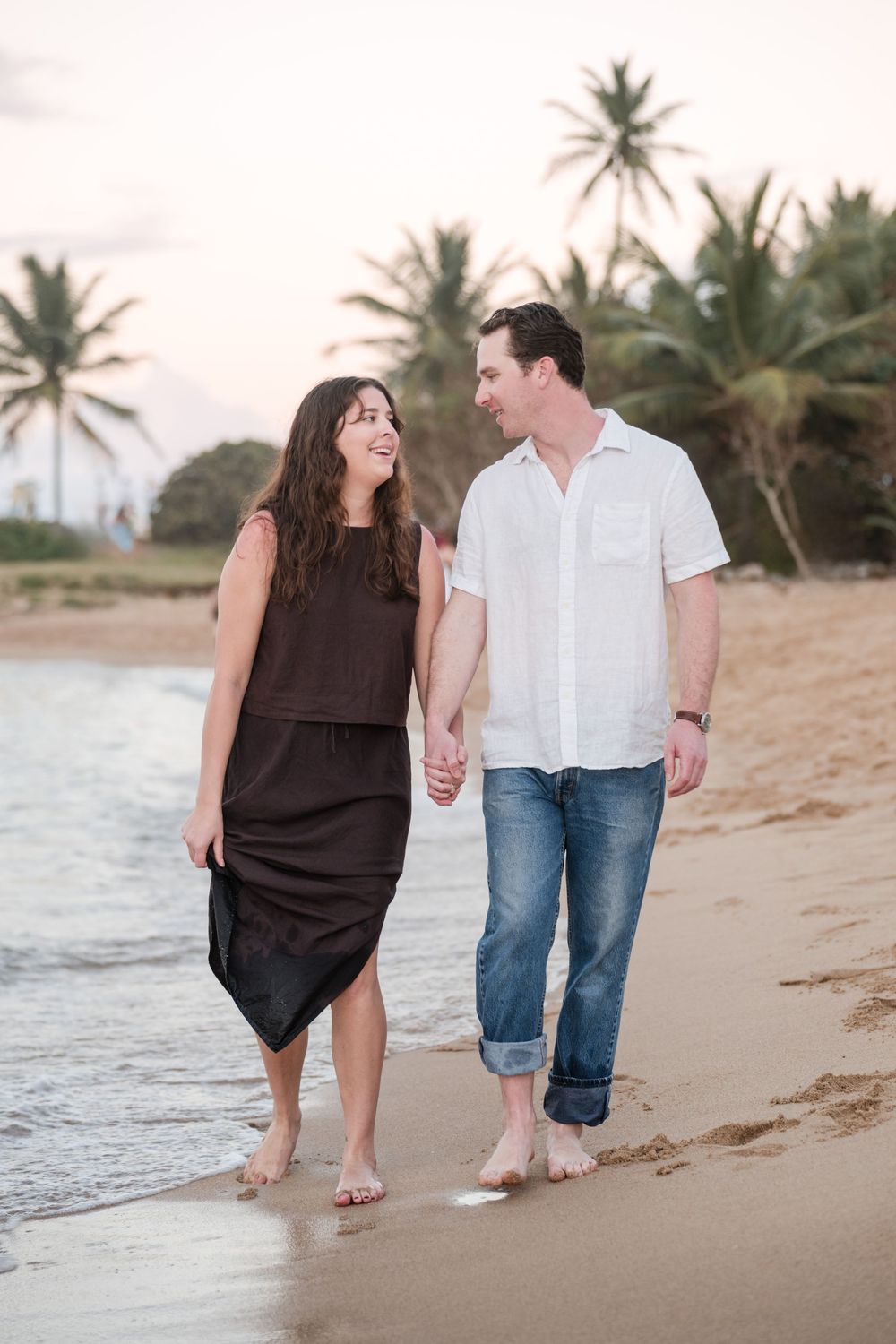 Couple walking side by side on beach during engagement session in Puerto Rico