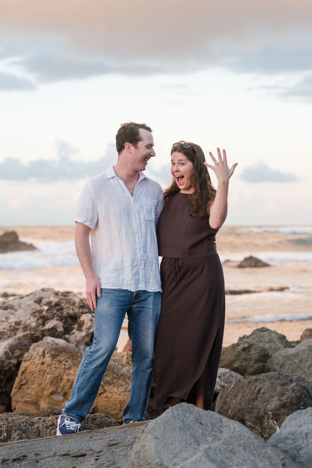 Couple posing together on rocks during engagement photos in Puerto Rico