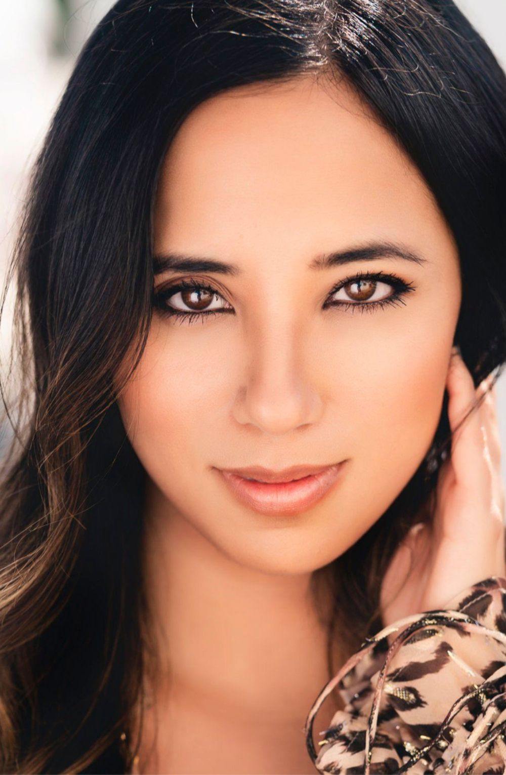 Close-up portrait series showing warm smiles and expressive eyes against a light background.