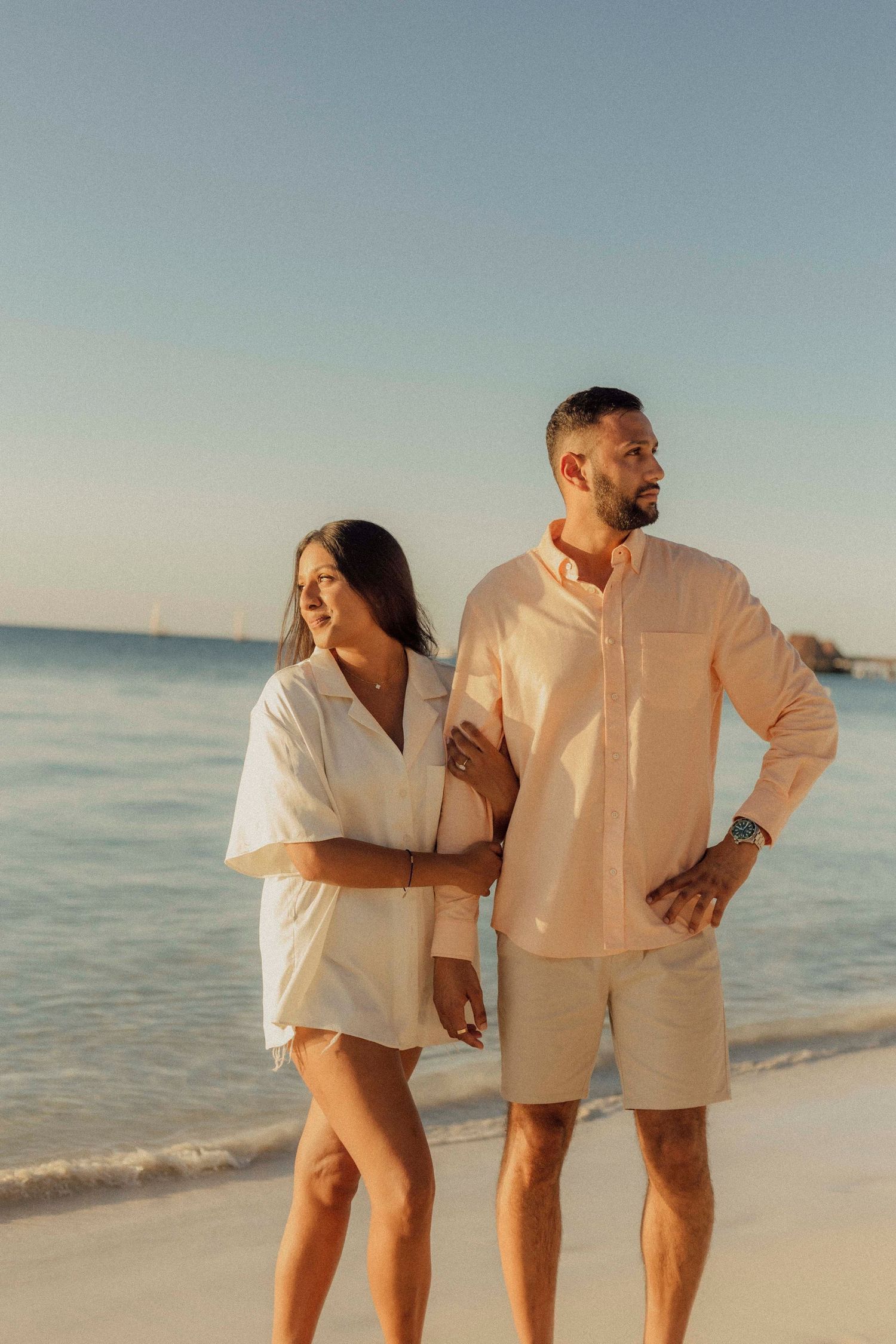 Couple walking along Nungwi Beach at sunset