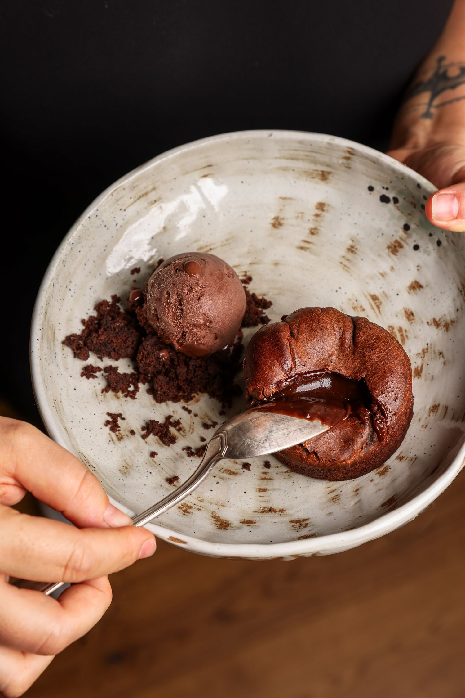 Sequence of photos showing chocolate ice cream being scooped and served on a white plate with messy chocolate crumbs.
