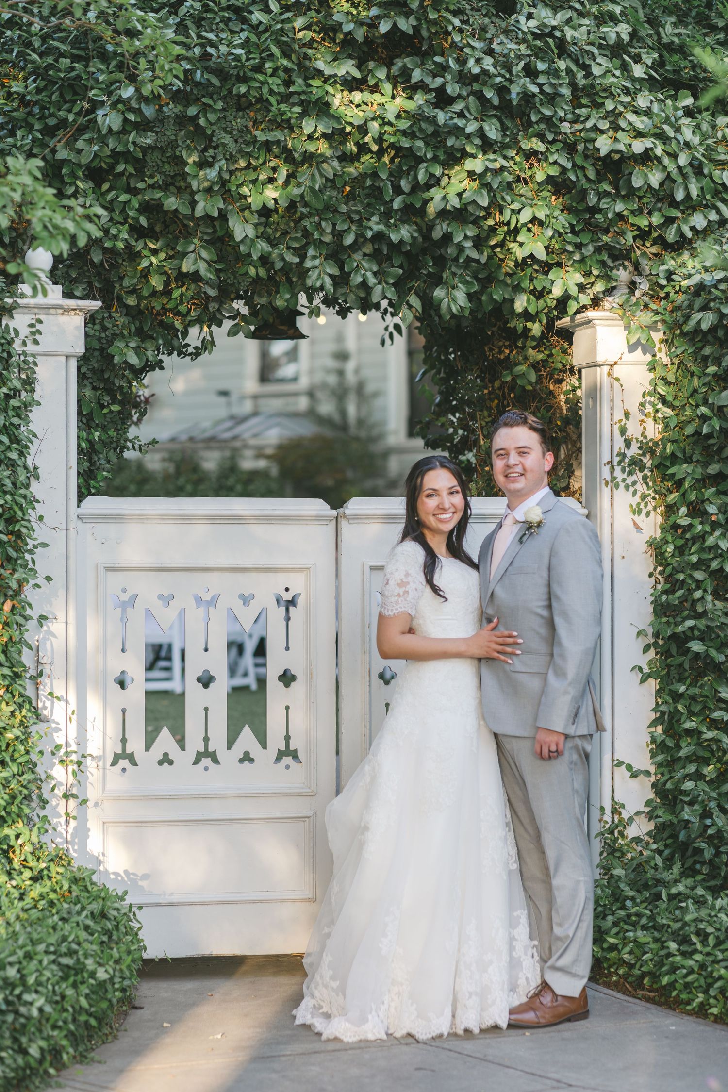 Couple by the garden gate at McHenry Mansion captured by Chelsee Rawe Photography