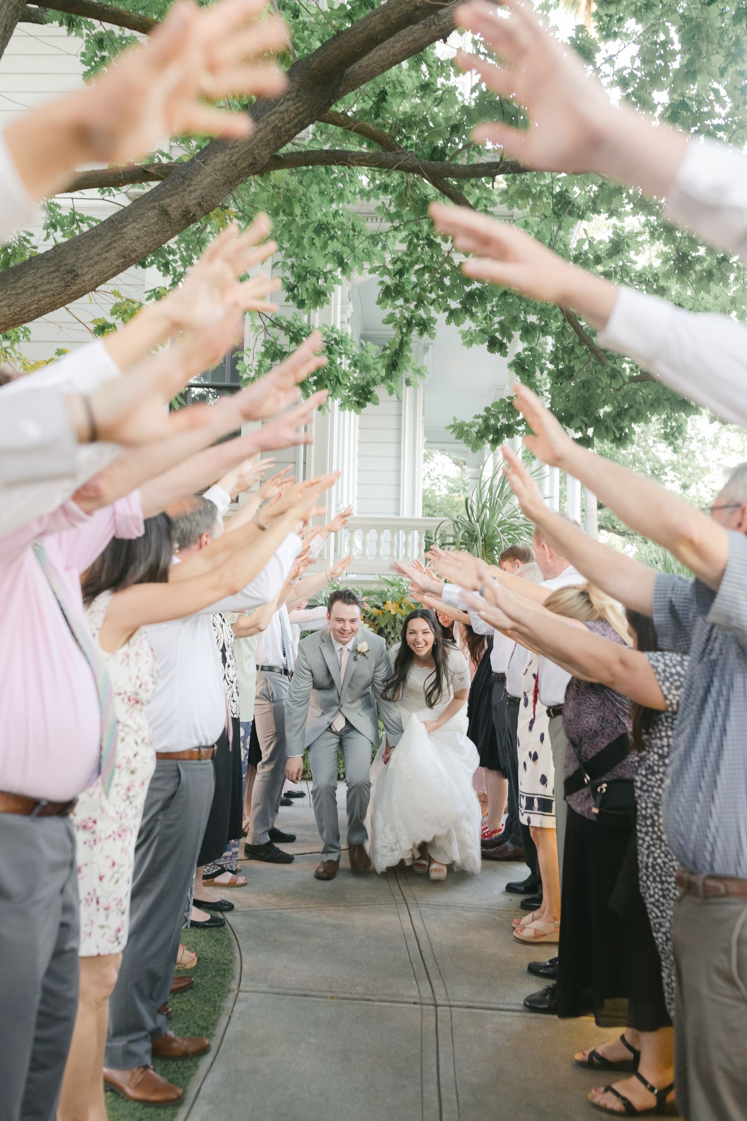 Bride and Groom exit tunnel from wedding reception captured by Chelsee Rawe Photography