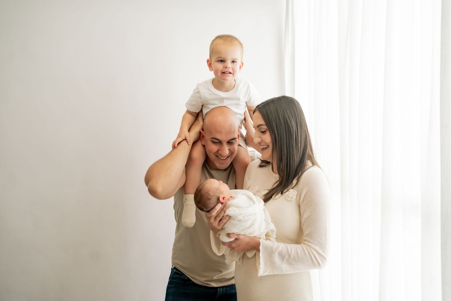 A tender family moment captured in soft natural light showing loving interactions and gentle embraces.
