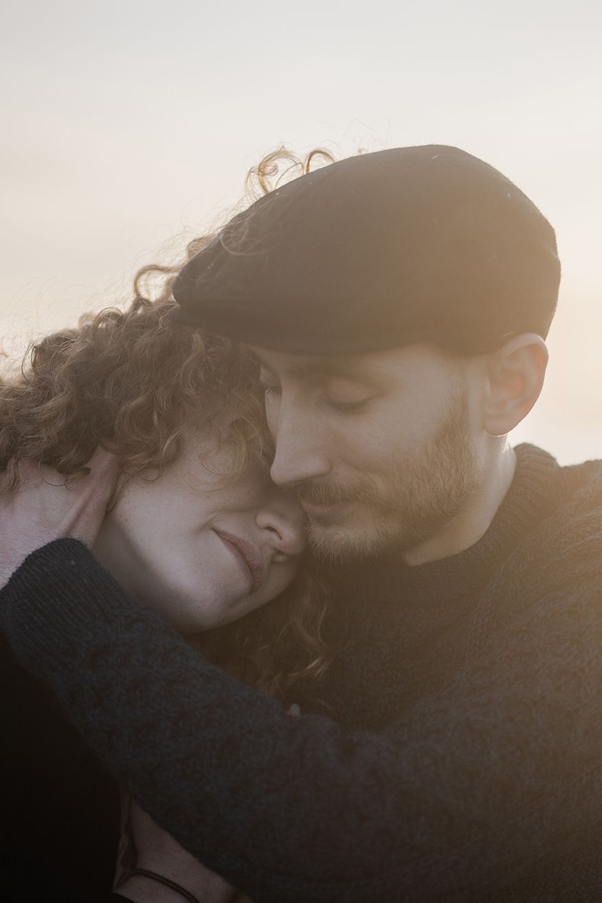 Intimate storytelling portraits capturing quiet connection between couple during Ireland sunset session