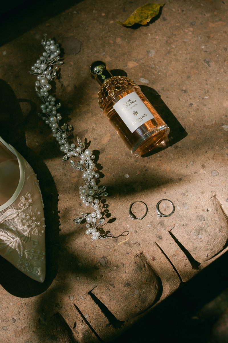 Vintage bottles and decorative items arranged on a weathered concrete surface with dramatic lighting.