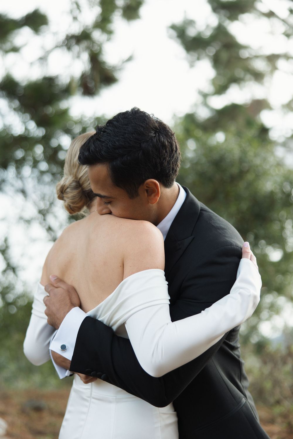 Couple hugging during their wedding first look at Marconi Lodge in Tomales Bay