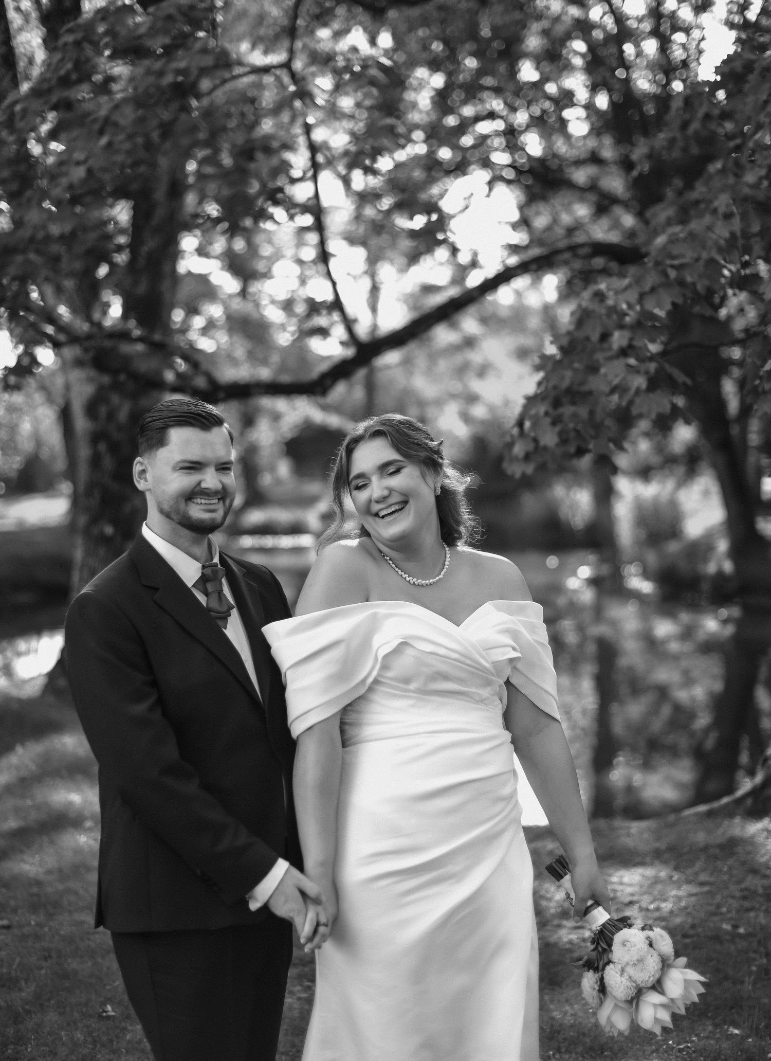 A joyful black and white wedding portrait sequence showing a couple sharing candid laughs in an outdoor garden setting.