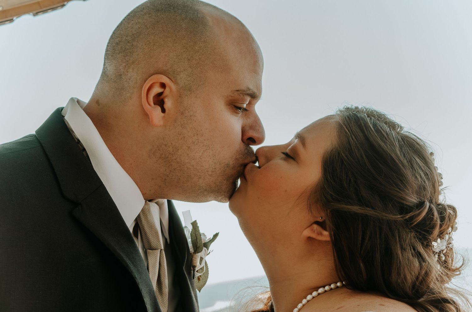 Close-up romantic moments captured during a wedding photoshoot.