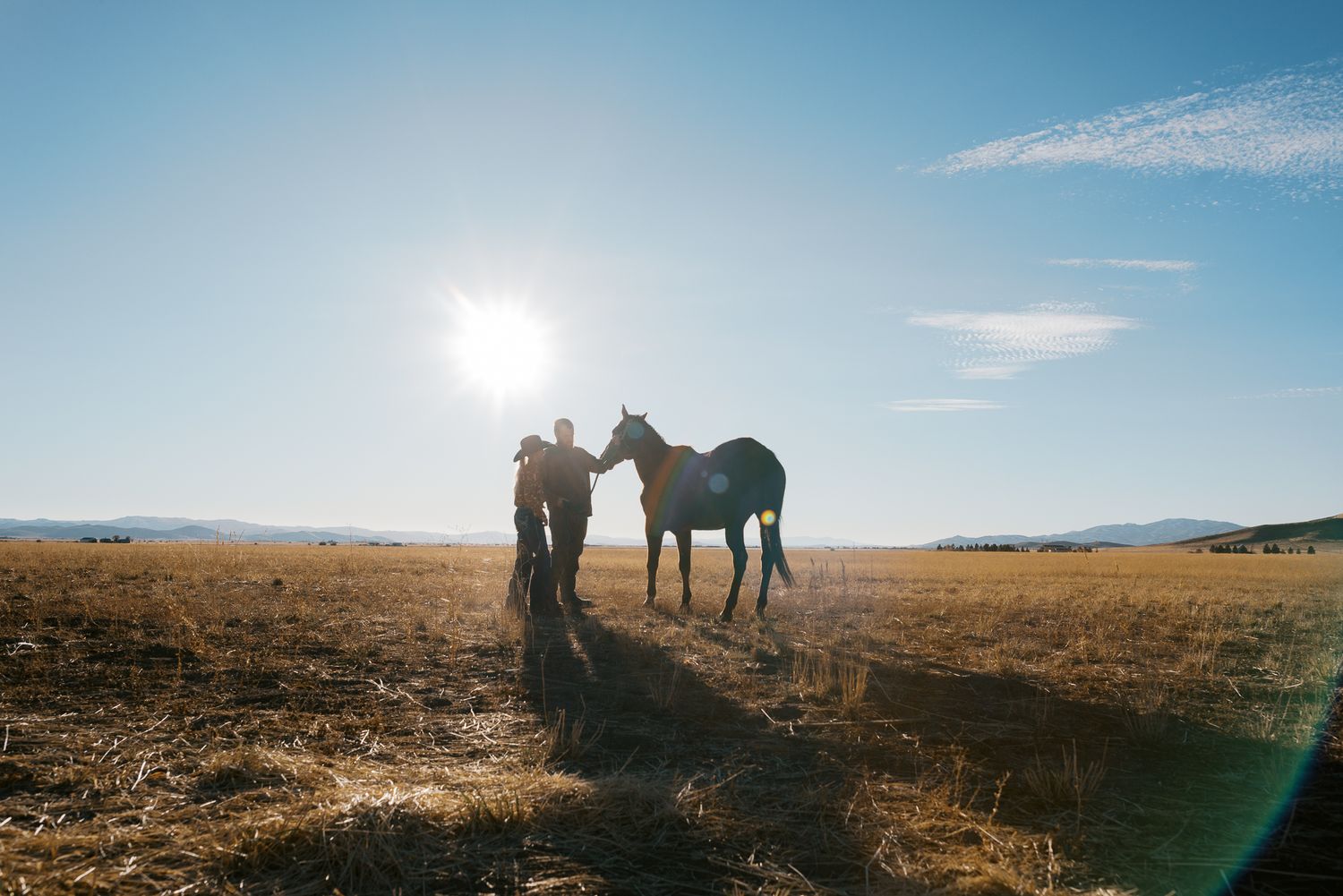a rancher and his daughter next to a beloved horse in idaho