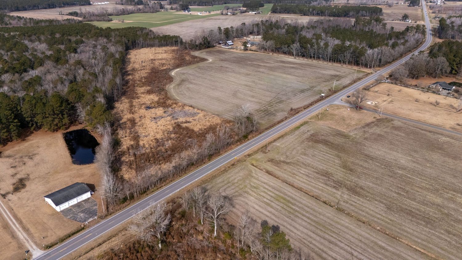 Aerial drone photography of vacant land highlighting lot size, access road, and surrounding landscape in Fayetteville, NC