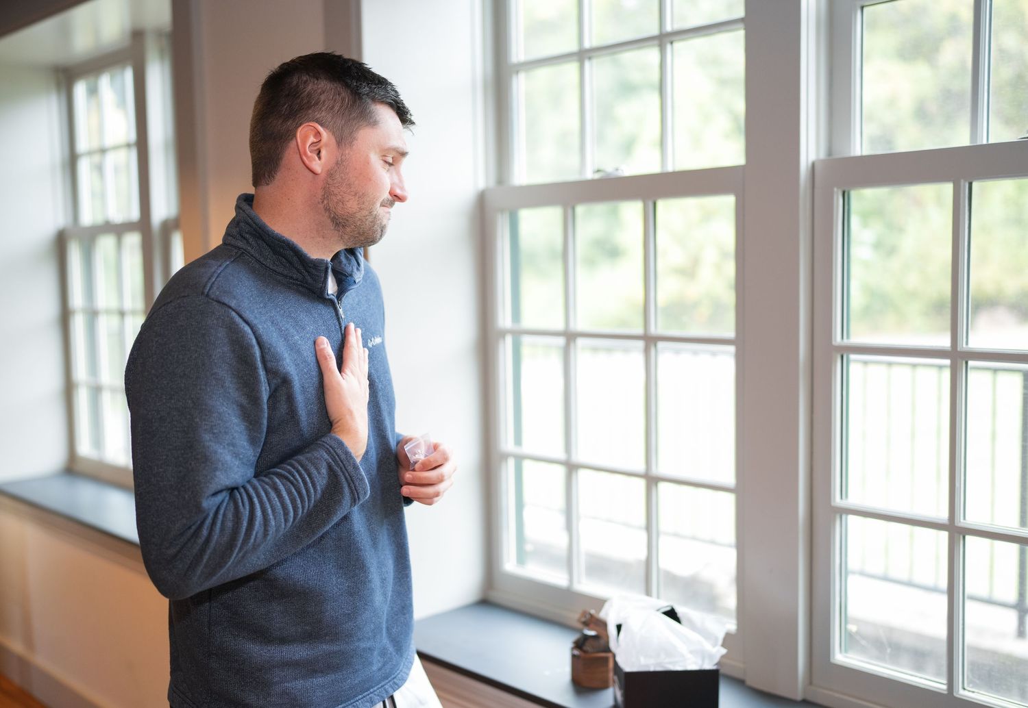 Emotional moment of groom getting ready during the morning portion of a Delaware wedding day timeline