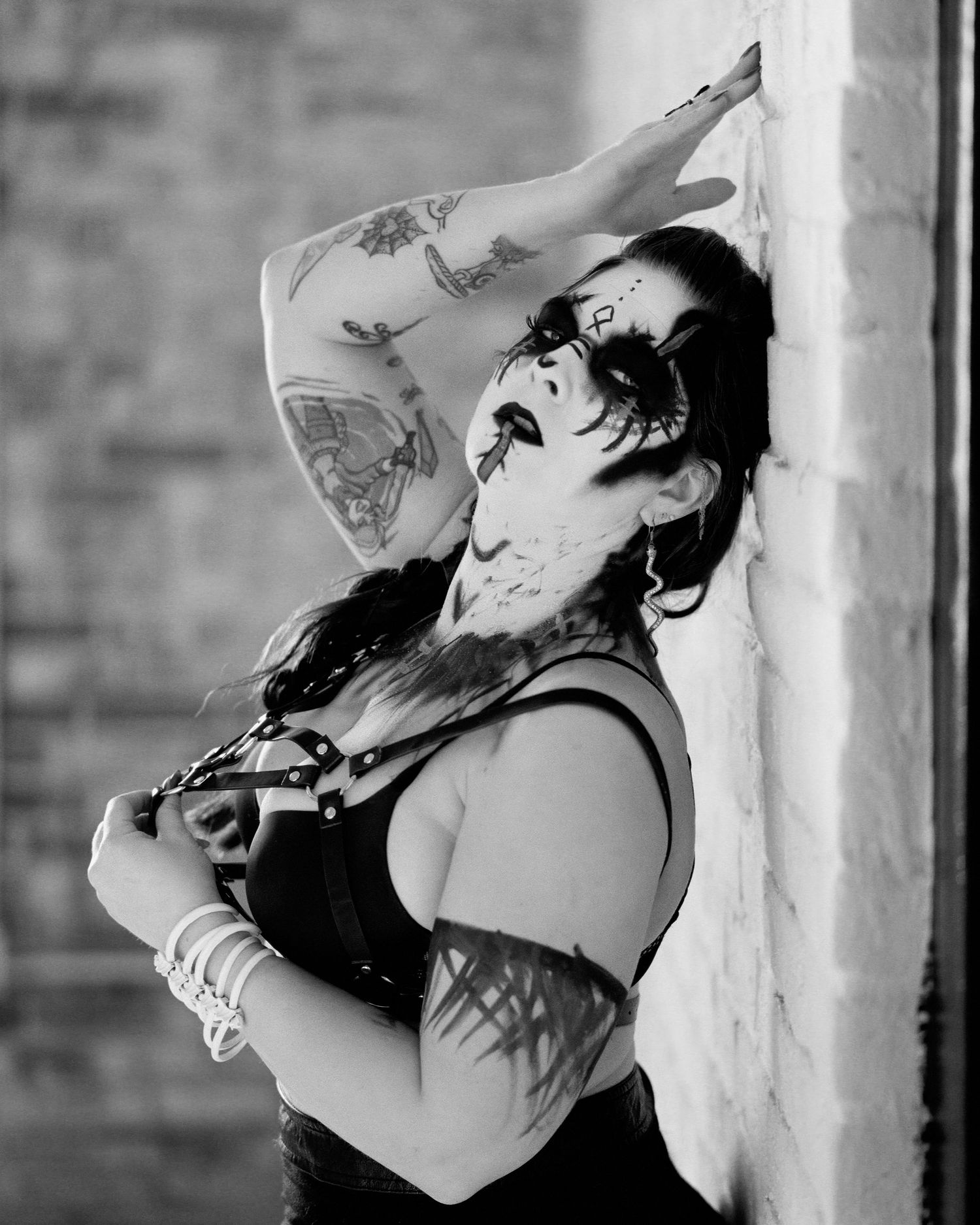 David G Holt Photography - Dramatic black and white photo series capturing emotional poses against a textured wall.