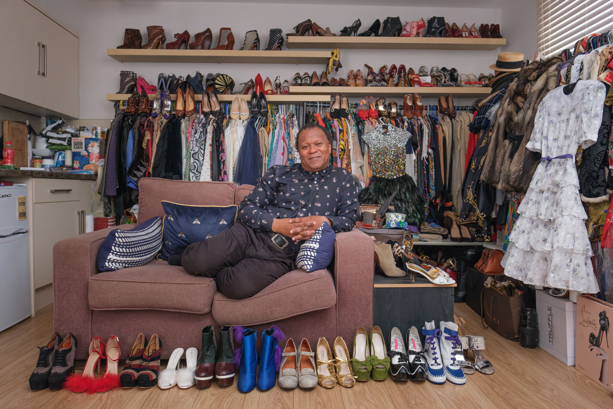 A closet organization system displays multiple rows of shoes, clothing, and accessories on shelves and hangers.