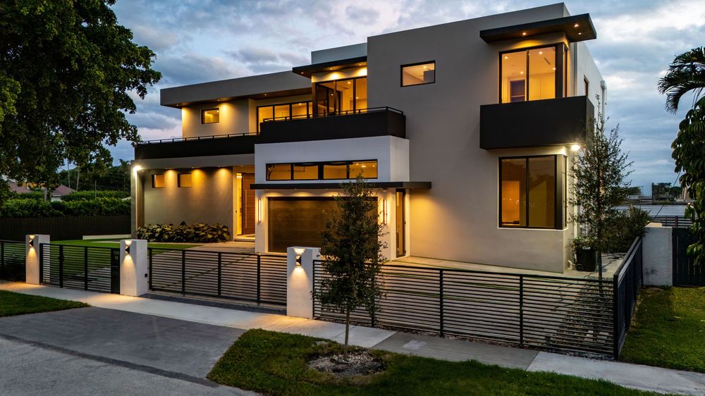 Panoramic twilight view of a contemporary luxury residence with dramatic lighting and clean lines.