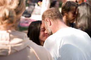An intimate moment shared between attendees at an outdoor celebration.