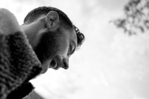 Close-up black and white profile portrait showing joyful expression.