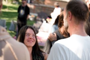 Happy attendees sharing joyful interactions at an outdoor gathering.