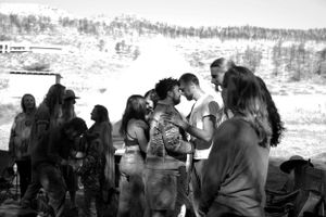 A crowd of people gathered outdoors in a snowy winter landscape.