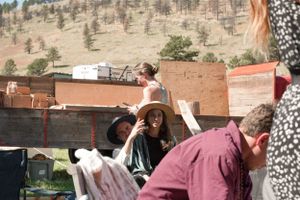 Group of attendees setting up at an outdoor event with mountain backdrop.
