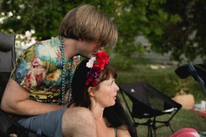 A gathering in an outdoor garden setting with beaded decorations and floral accessories.