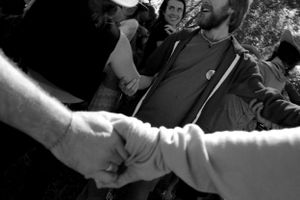 Close-up black and white shot of hands joining together in unity.