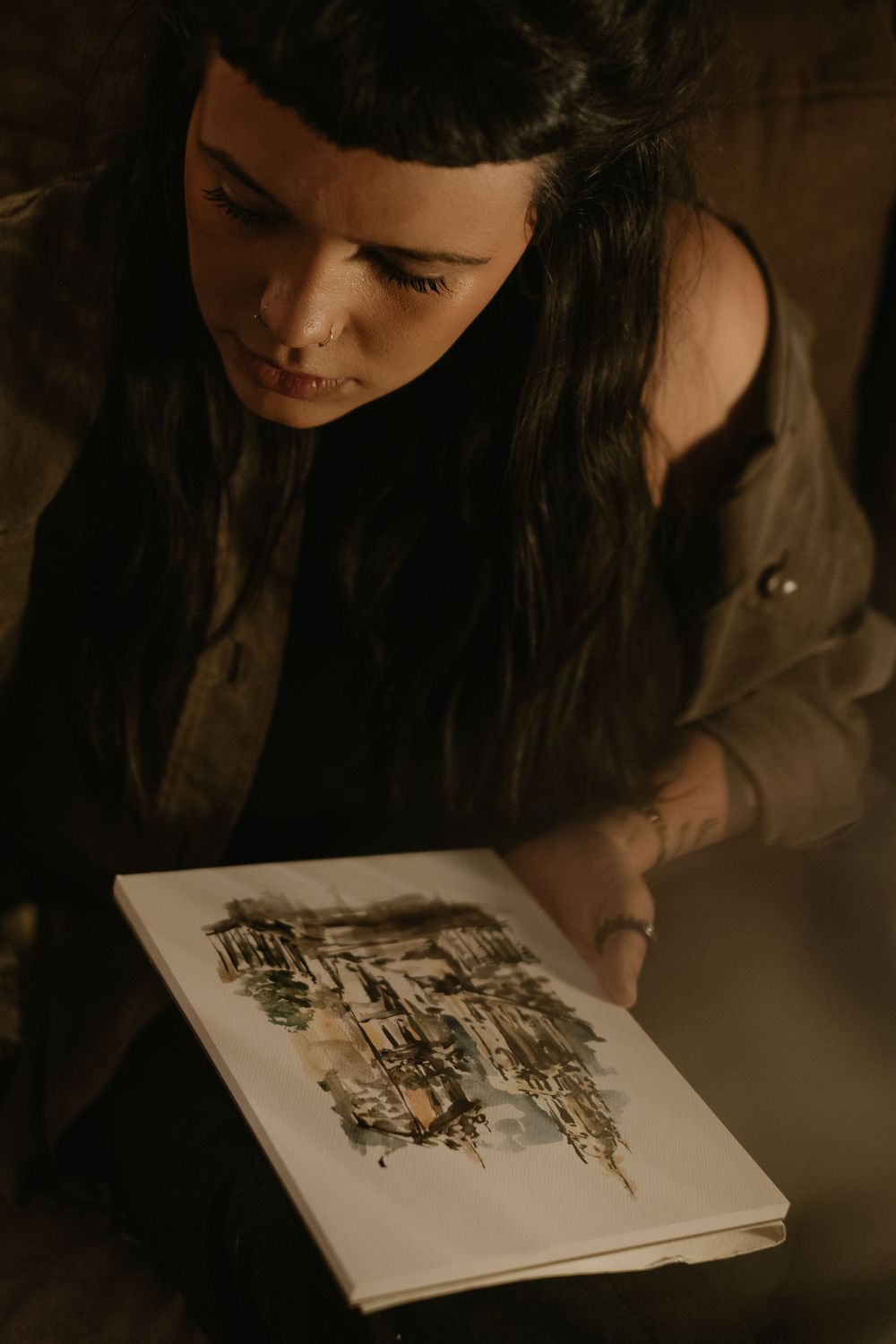Drawing details in a sketchbook illuminated by soft lighting.