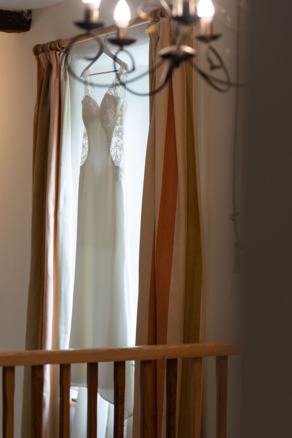 Interior view of elegant window treatments with hanging decorative lights.