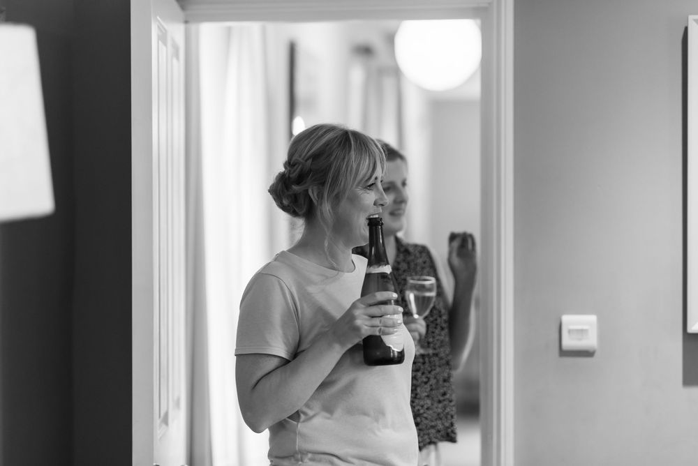 Black and white photos of wedding preparation in bright room.