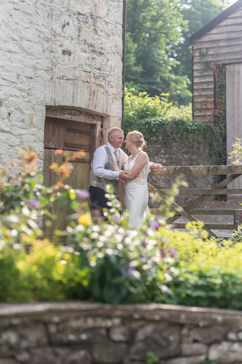 Couple shares romantic moment in stone courtyard garden.