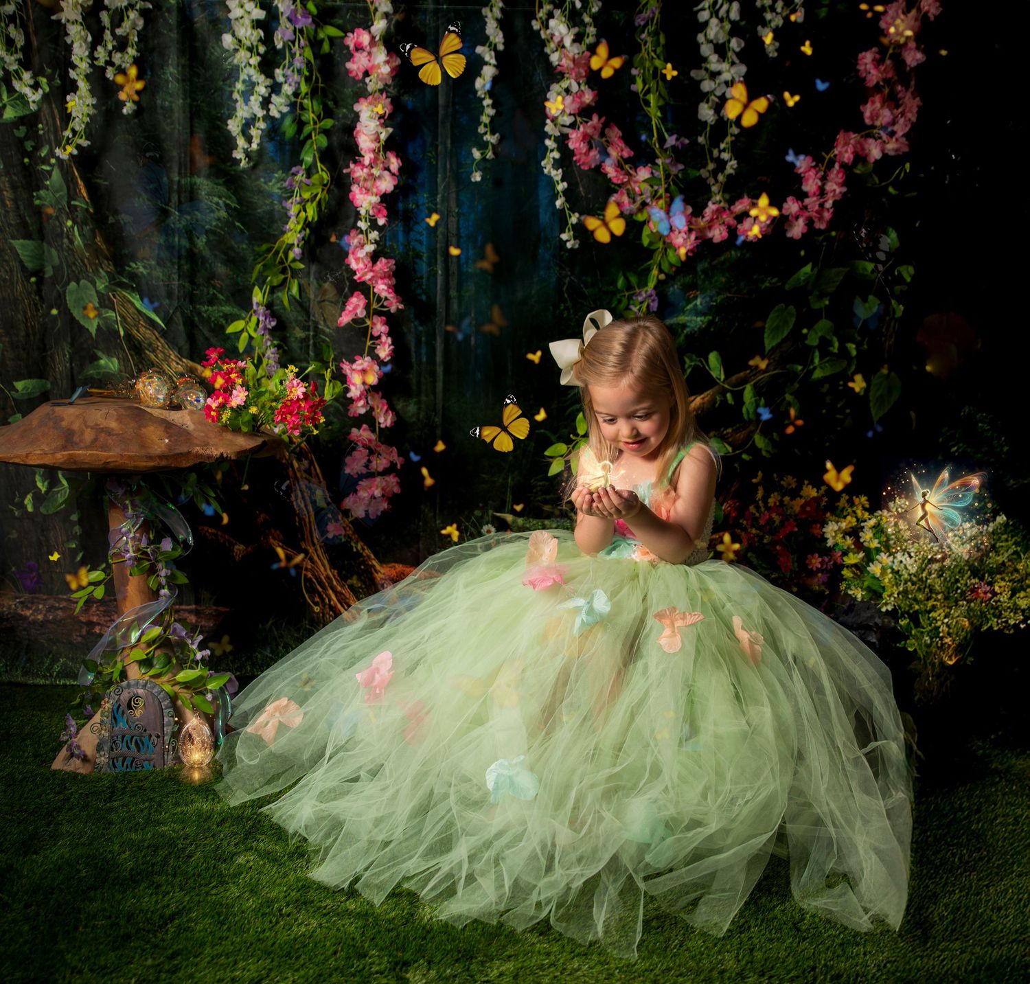 Beautiful portrait in a garden setting with soft pink flowers and a flowing mint green tulle dress with pearl accents.