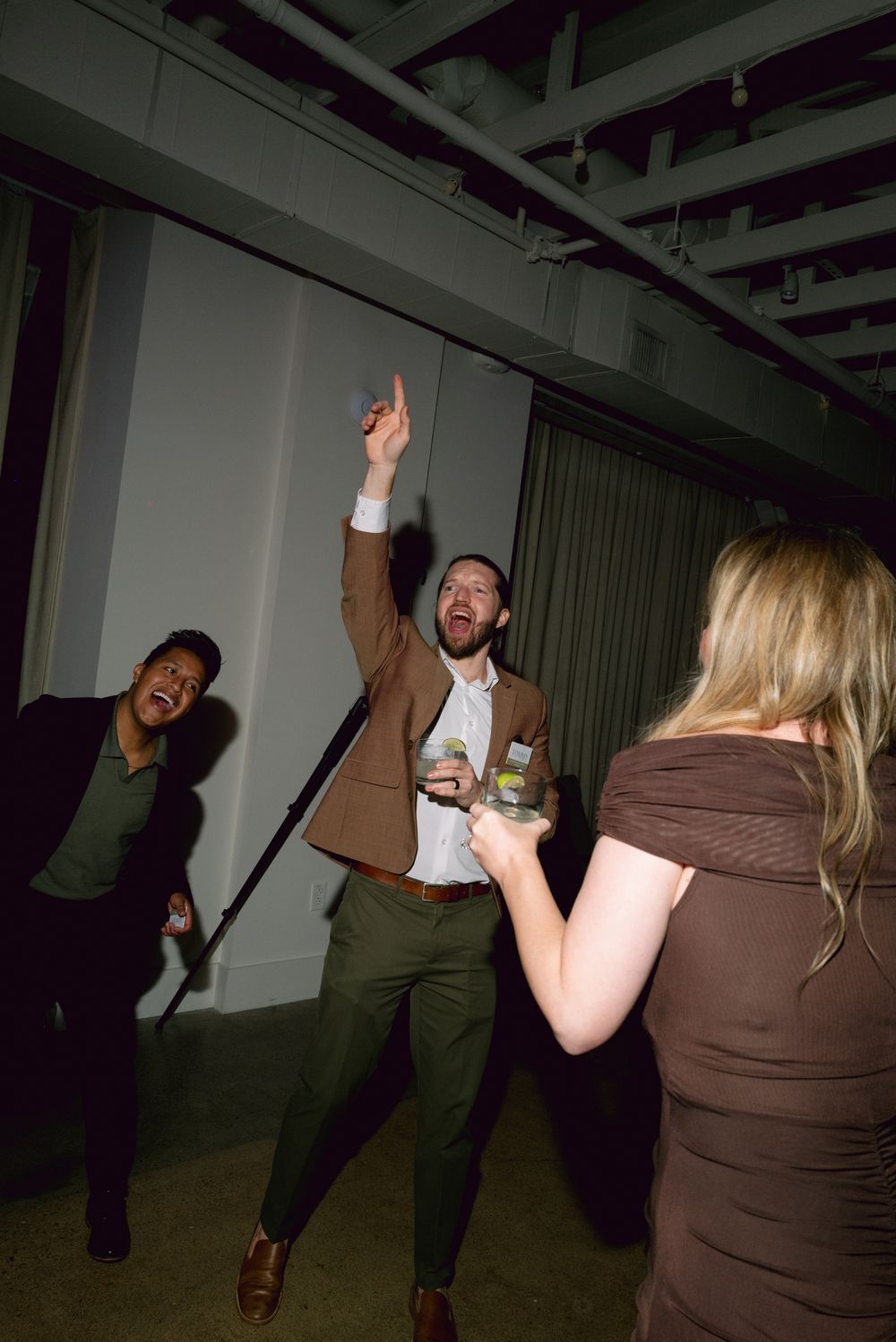 People dancing and having fun at what appears to be an indoor party or event space.