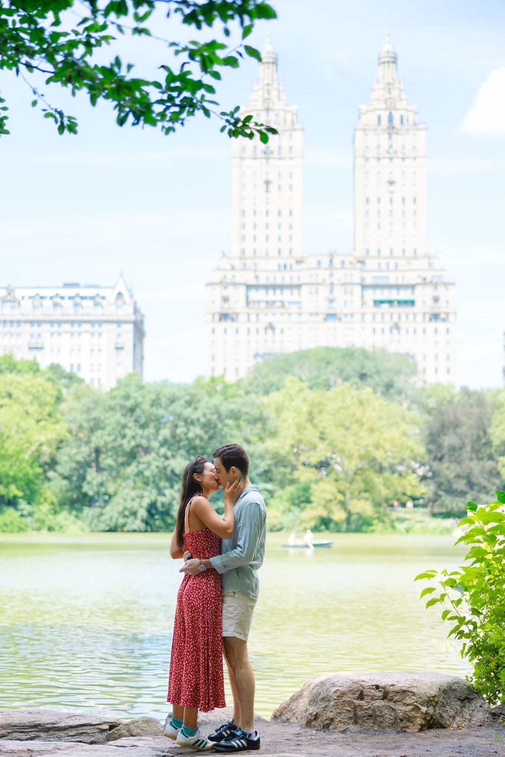 Romantic proposal moment overlooking The Lake at San Remo lookout in Central Park, New York City.