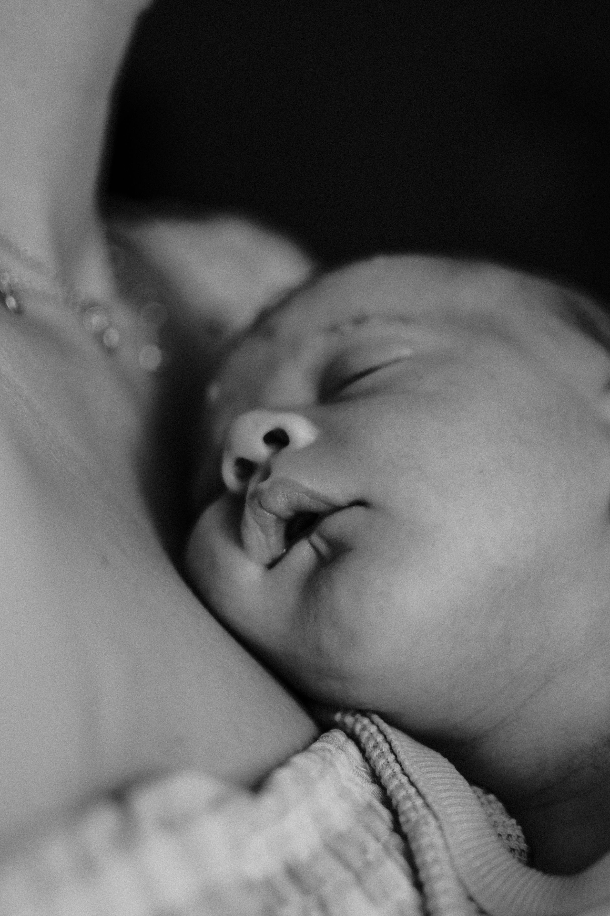 Black and white close-up of peaceful sleeping baby's face.  Indoor Newborn Session Arlington Texas