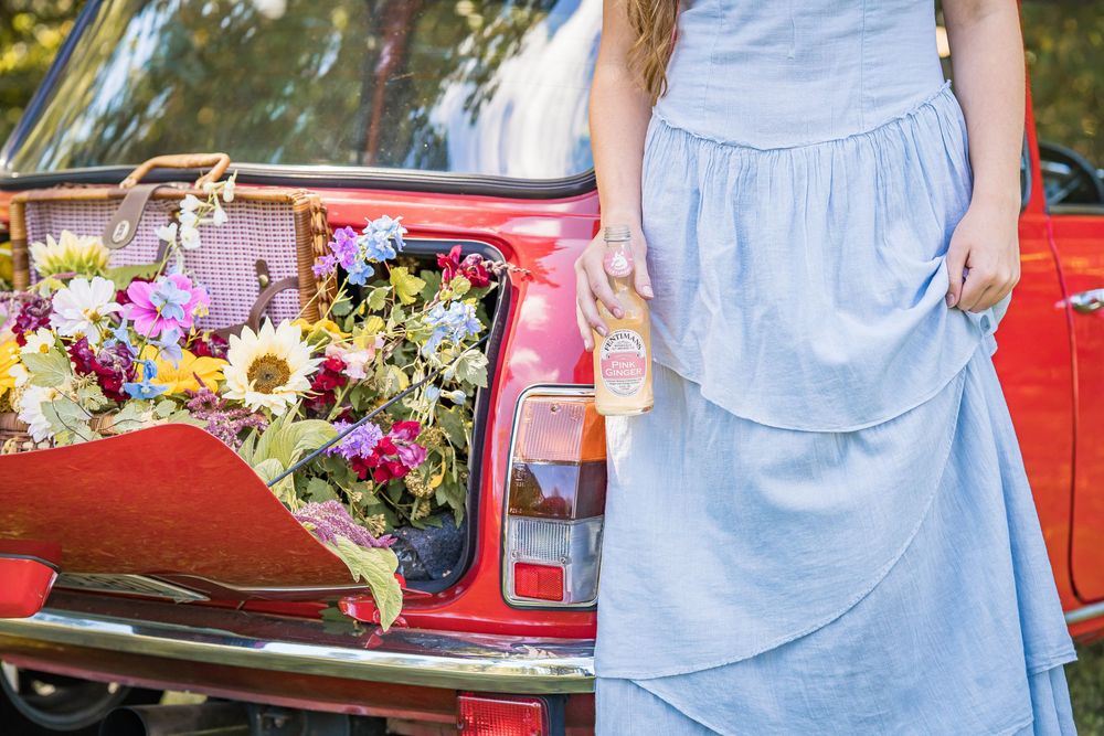 styled photography senior mini session with red classic mini Cooper car and seasonal flowers