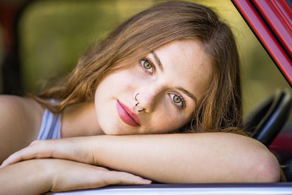 styled photography senior mini session with red classic mini Cooper car and seasonal flowers