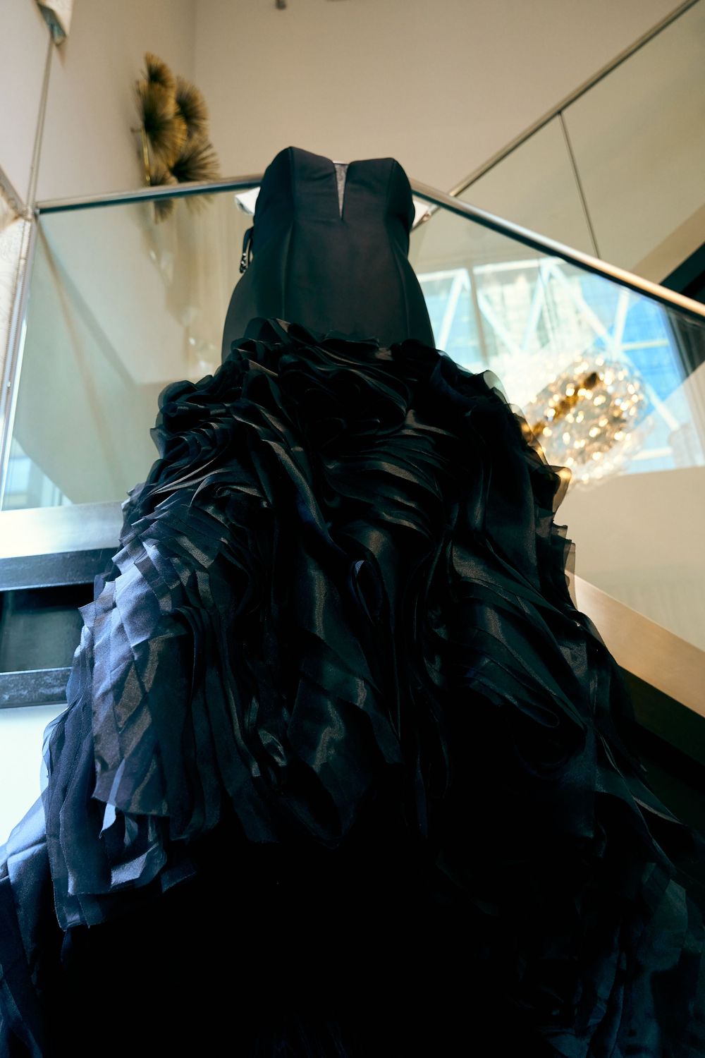Dramatic black wedding dress with layered ruffles photographed from below.
