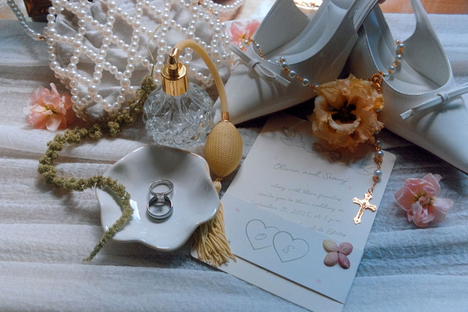 A beautiful floral arrangement with dried preserved flowers in soft pastel shades of blue, cream and brown peeks through.