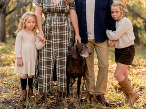 Artistic woodland photo series featuring people and their dog in autumnal setting with warm golden lighting.
