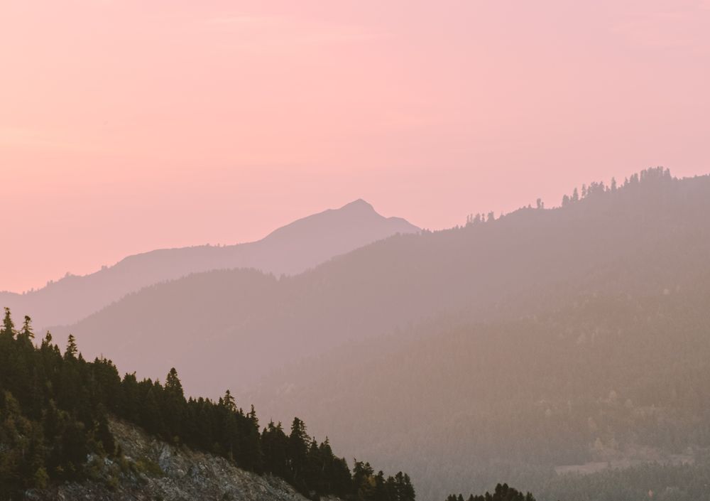 Mountain silhouettes at sunset with pink sky