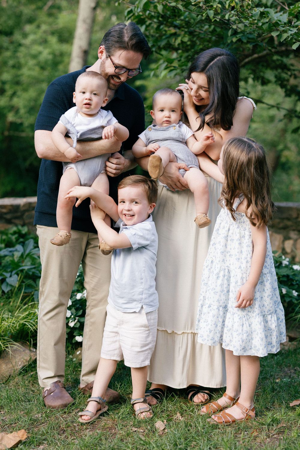 A series of candid family moments showing playful interactions outdoors in coordinated white and beige clothing.