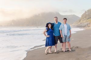 A series of beach portraits showing people in blue outfits against a scenic coastal backdrop at sunset.