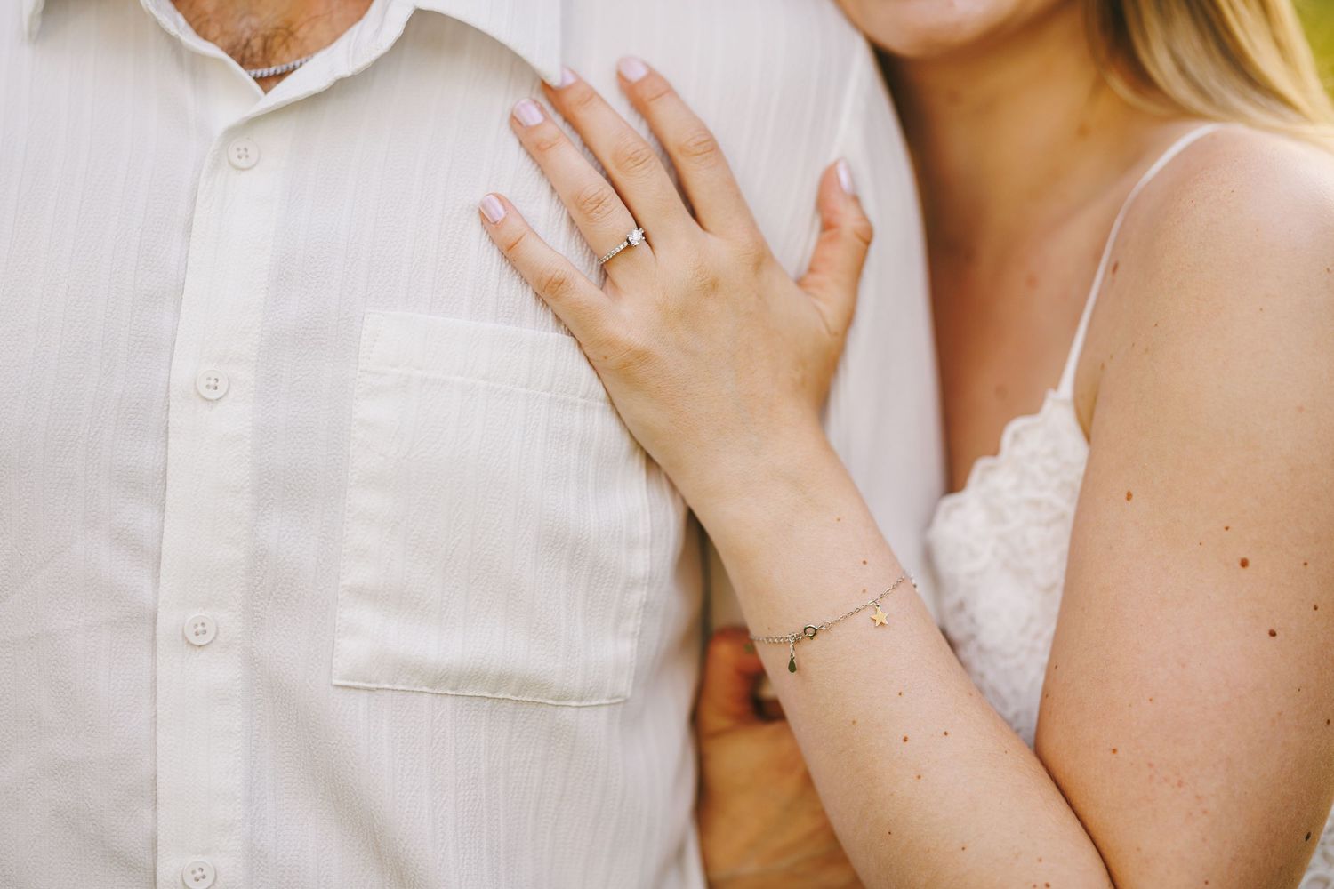 Happy couple sharing an intimate moment together in white wedding attire.