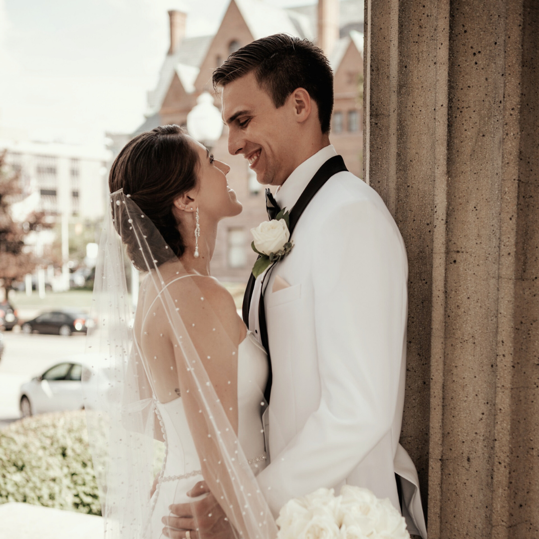 Intimate wedding portraits captured between stone columns.