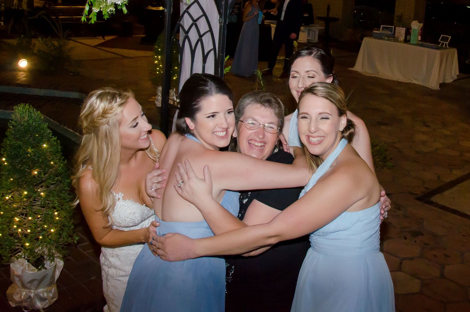 Wedding party posing on Tampa FL concrete steps while Vazul Studios photographer captures the moment.