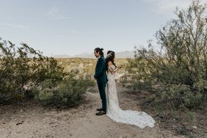 A romantic desert wedding photo series showing couple silhouettes against a golden sunset in the Arizona desert.