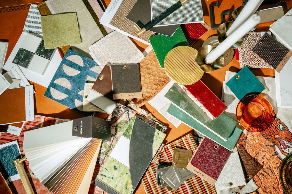 A colorful assortment of paper products, notepads, and craft materials scattered across a flat surface.